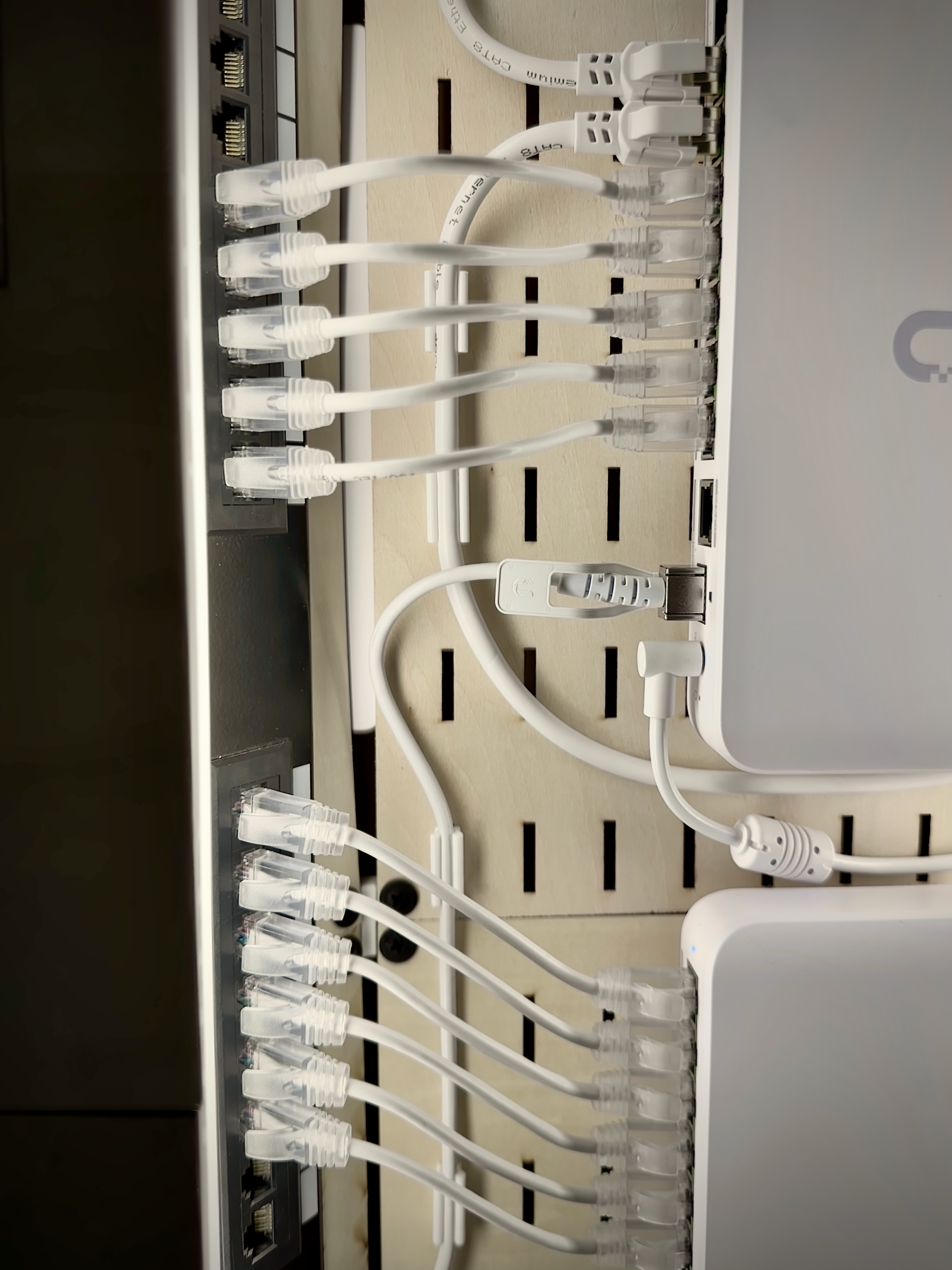 6-inch patch panel cables connect my home's ethernet runs to two switches, which are linked together with a Unifi 10G SFP uplink cable.